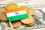 Indian flag resting on a pile of Euro coins with a US one dollar bill in the background