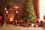 Festive living room, with Christmas tree by mantle piece, presents underneath